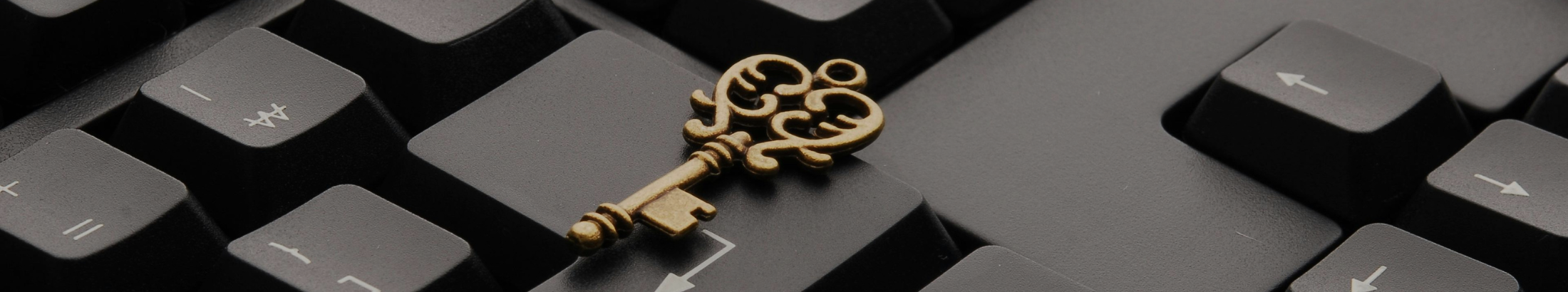 A  door key resting on the Enter key of a black keyboard.