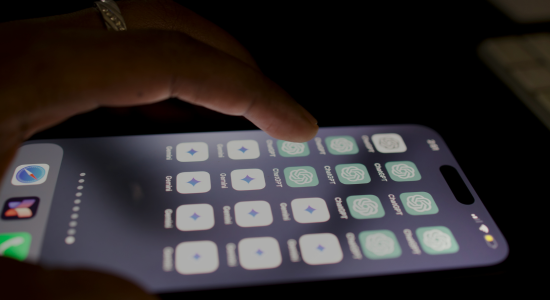 A close-up of someone using their smartphone with several ChatGPT and Google Gemini app icons on the display