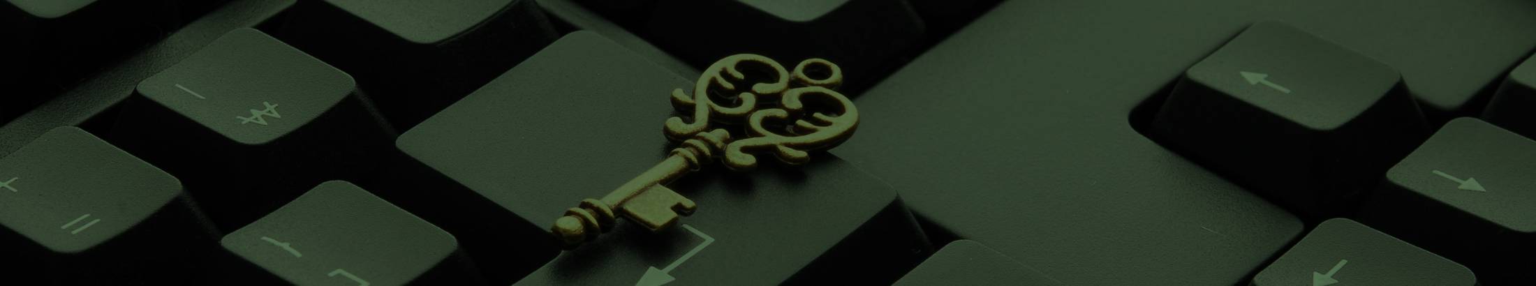 A door key resting on the Enter key of a black keyboard.