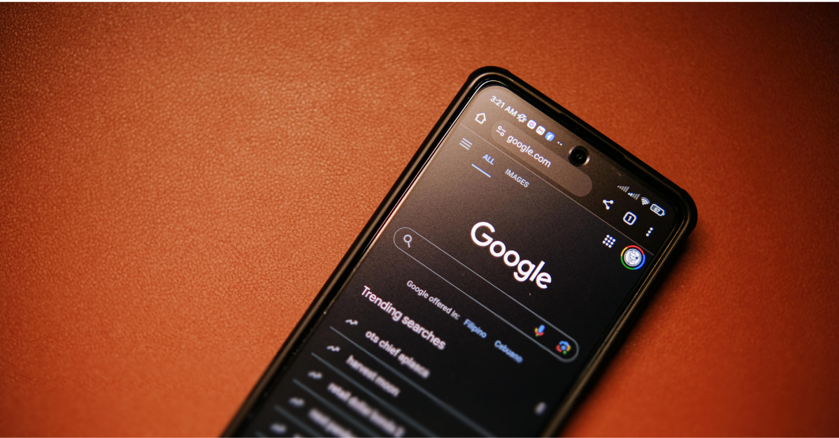 A smartphone on a red surface, showing the Google Search UI