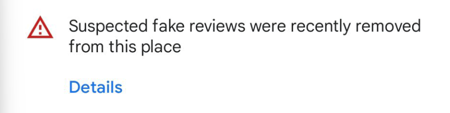 Screenshot of fake review removal warning from Google